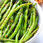 Easy green beans on a kitchen towel with red pepper flakes