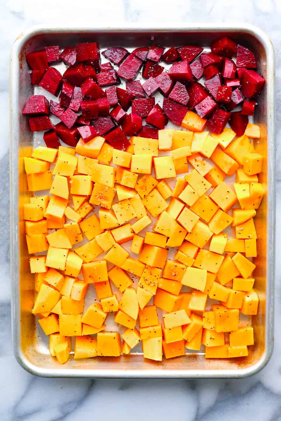 Beets and squash cubed on a sheet pan. 