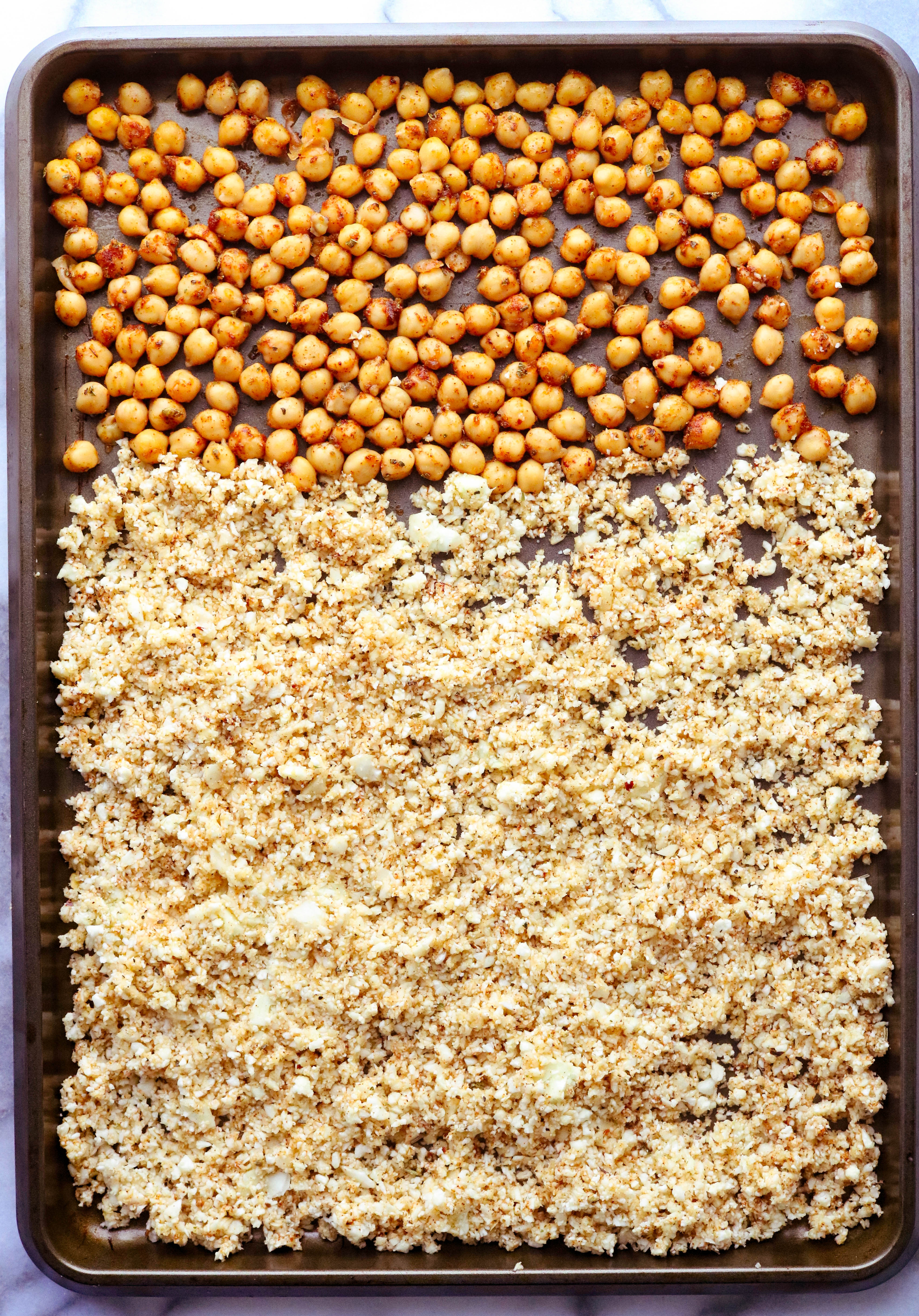 Roasted cauliflower rice on a sheet pan with chickpeas