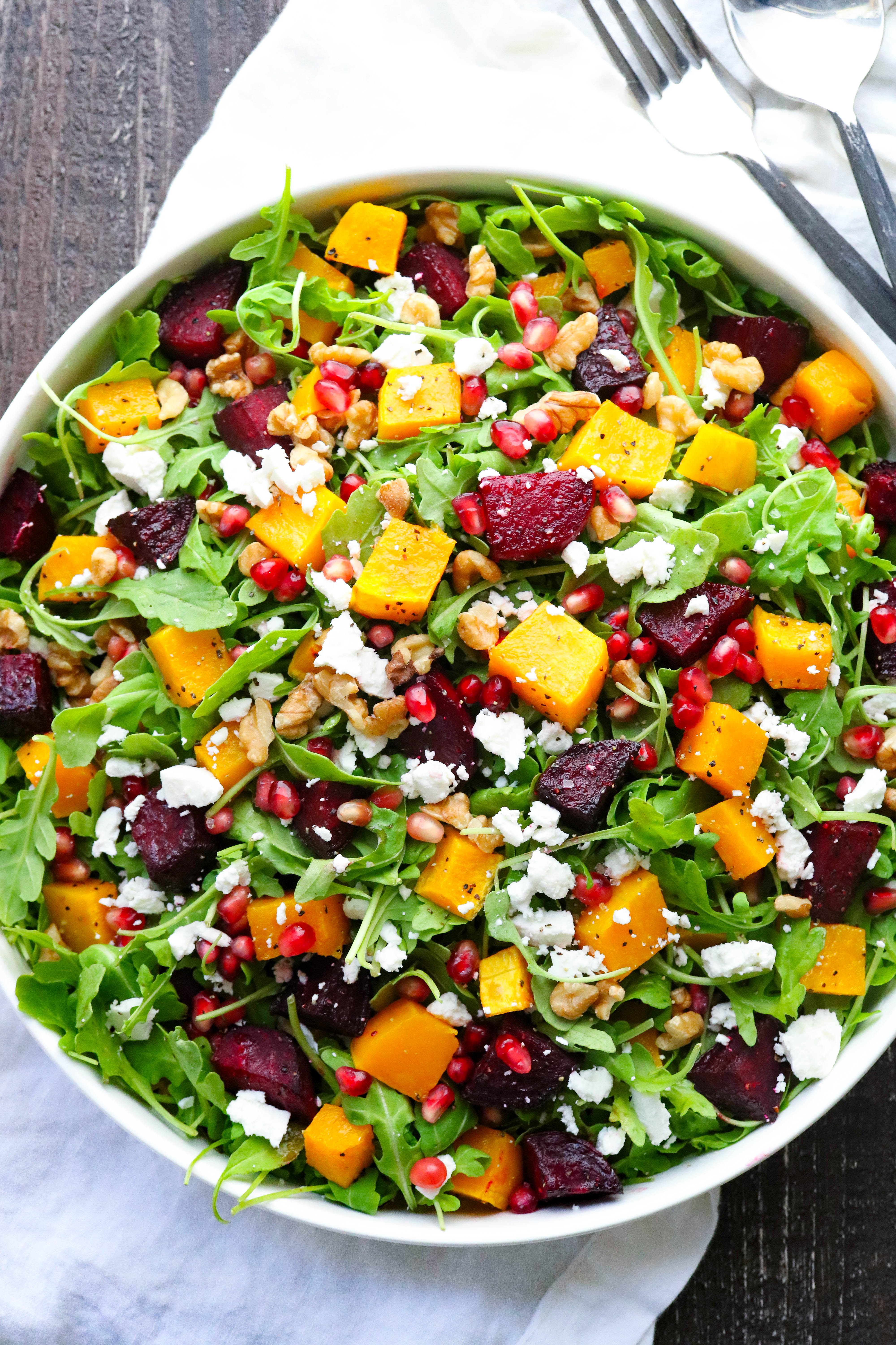 Salad with roasted beets and butternut squash with nuts and pomegranate seeds. 