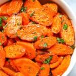 Easy ranch roasted carrots in a white bowl with herbs