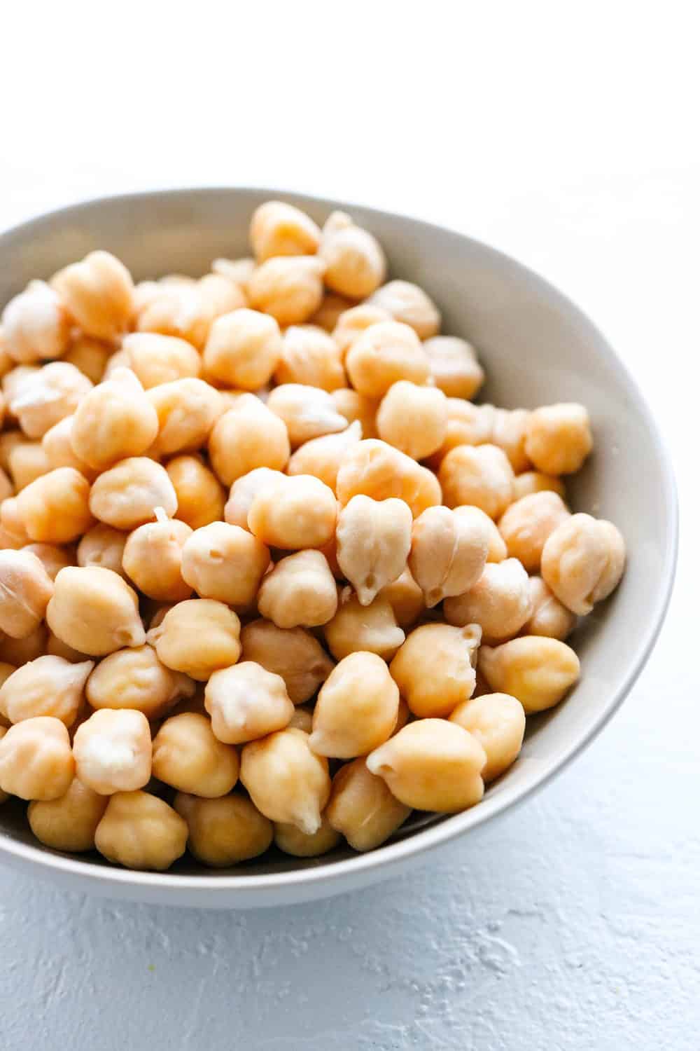 Bowl of chickpeas on a white board
