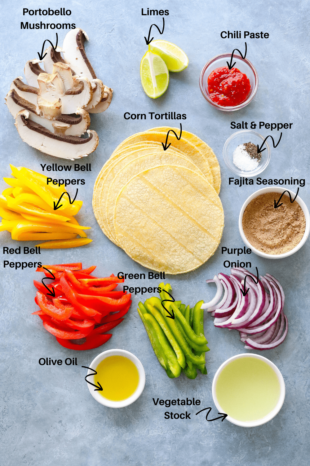 Vegetarian Fajita ingredients on a gray board including tortillas and mushrooms