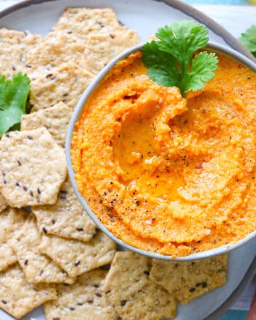 veggie dip in bowl with crackers next to it
