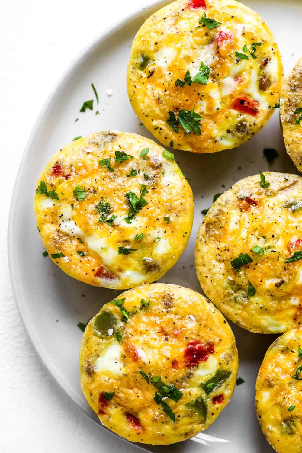 Easy healthy breakfast sausage egg muffins on a round grey plate