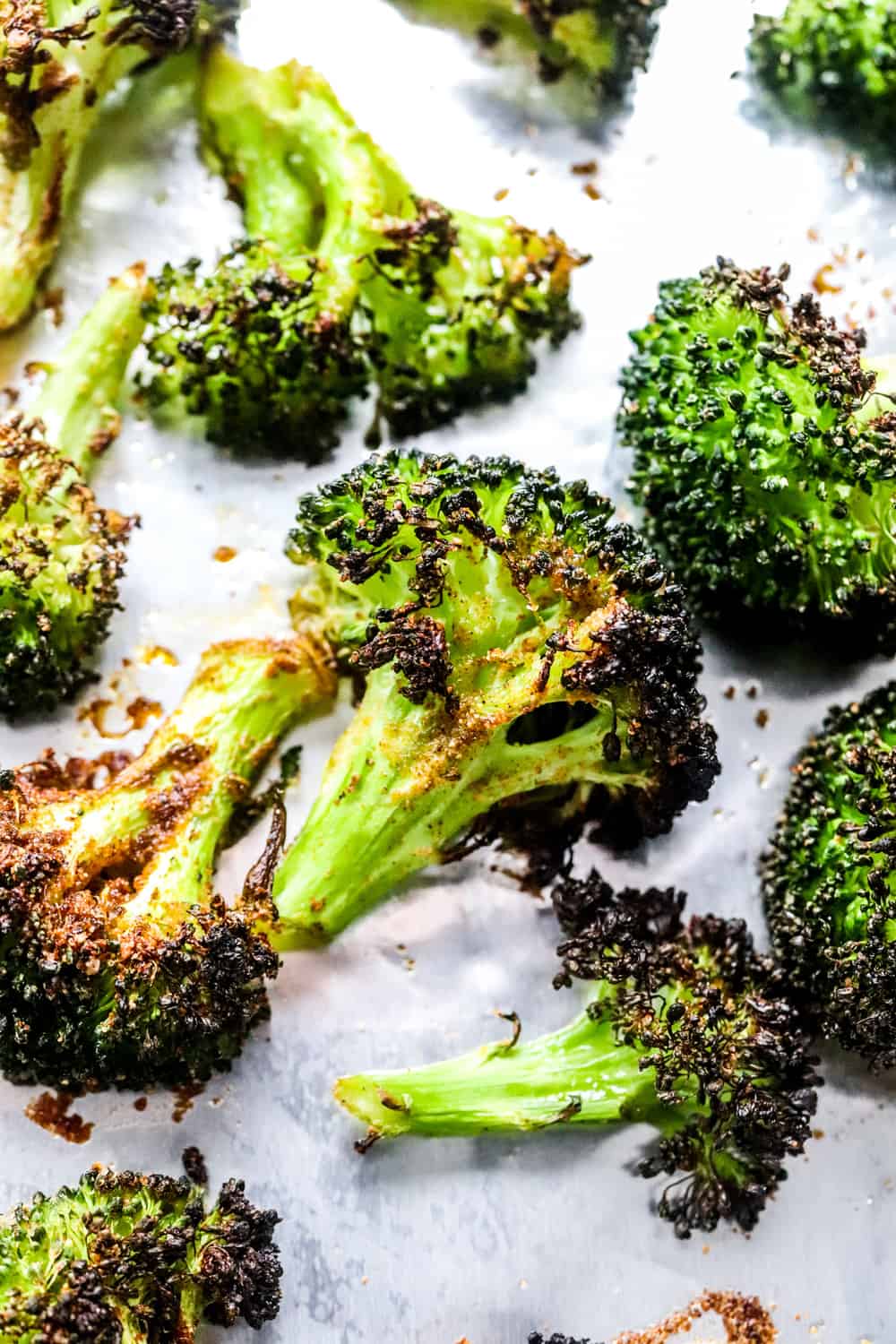 close up of crispy broccoli floret on a baking sheet. 