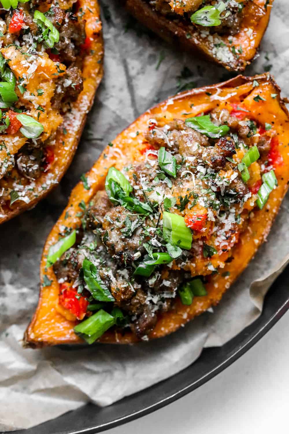 Roasted sweet potato filled with sausage and pepper filling with more sweet potatoes around it. 