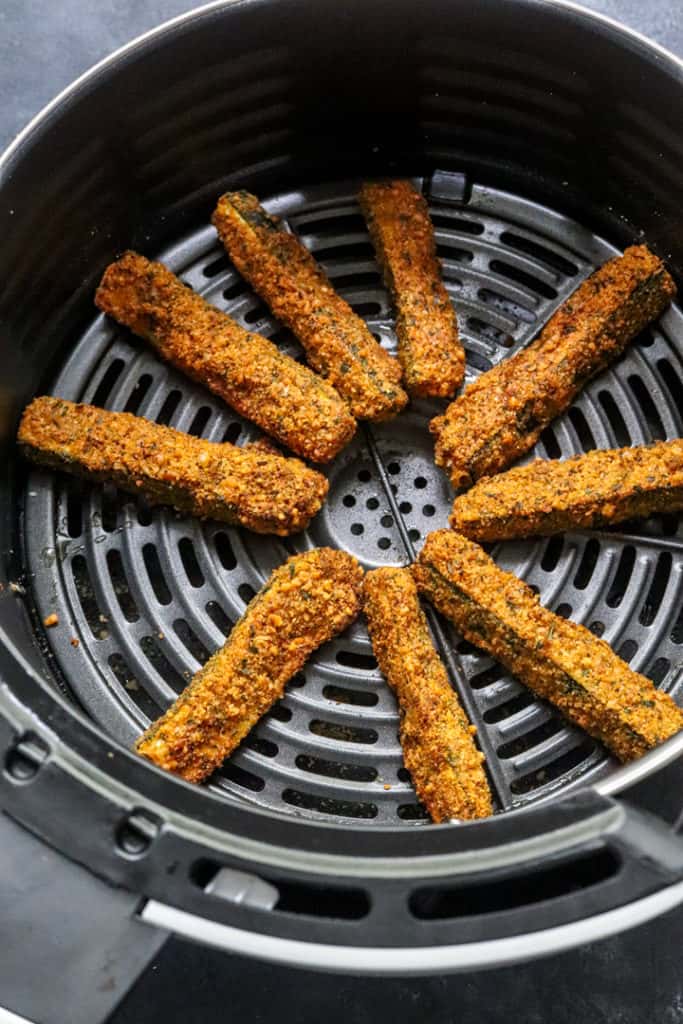 crispy cooked zucchini fries in an air fryer basket