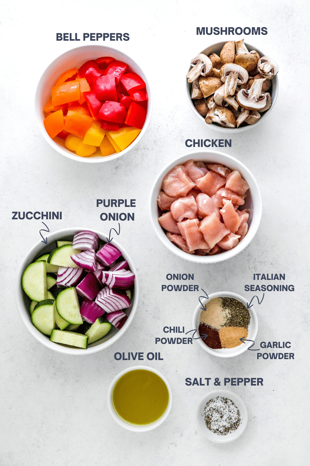 Ingredients for air fryer chicken and vegetables with labels over each ingredient. 