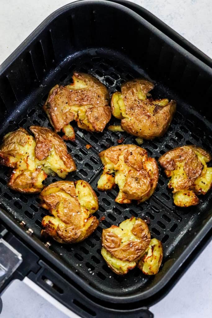 Crispy smashed round potatoes cooked in a squash air fryer basket