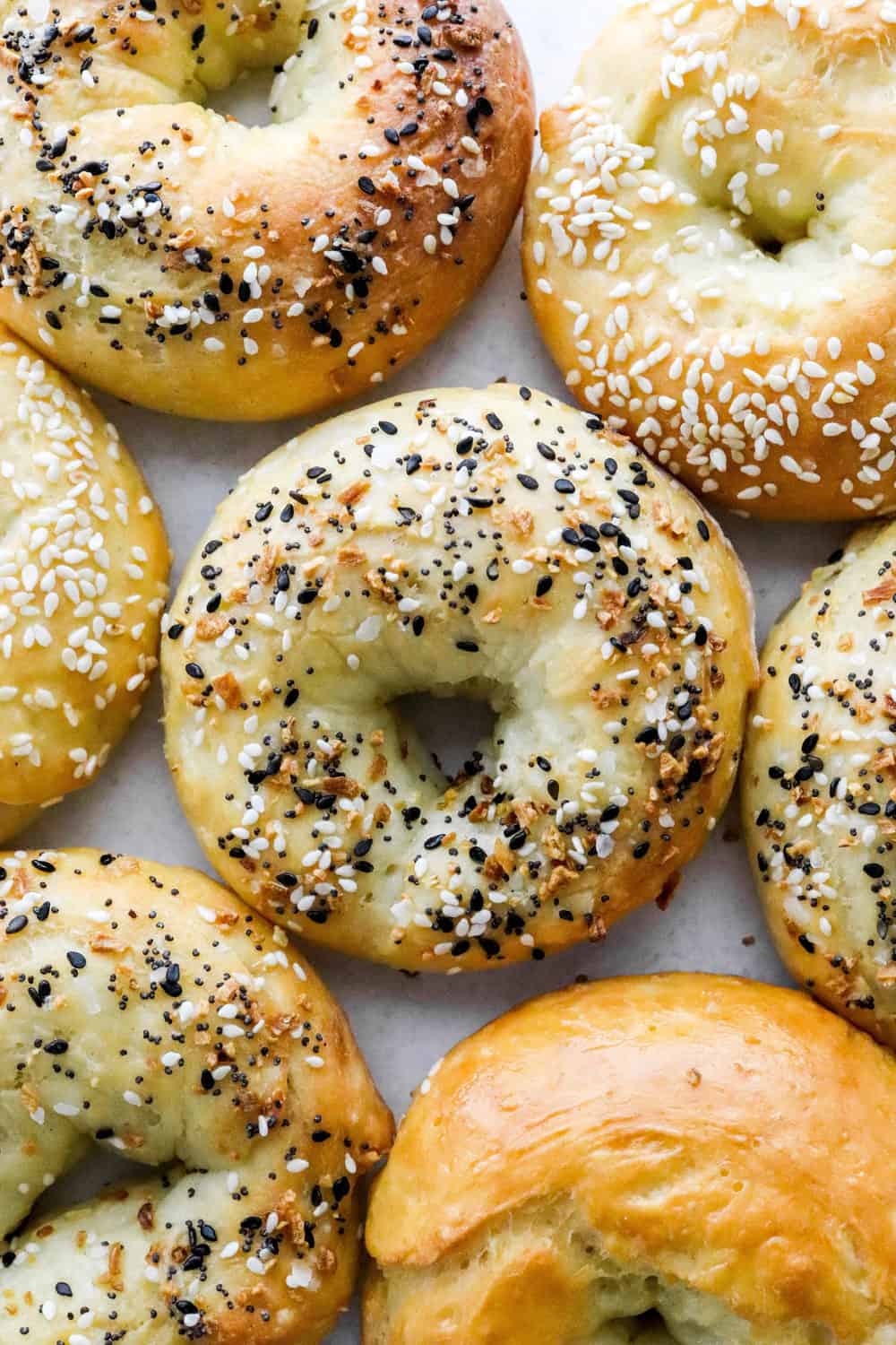 Several seasoned, air fried bagels on a white surface. 