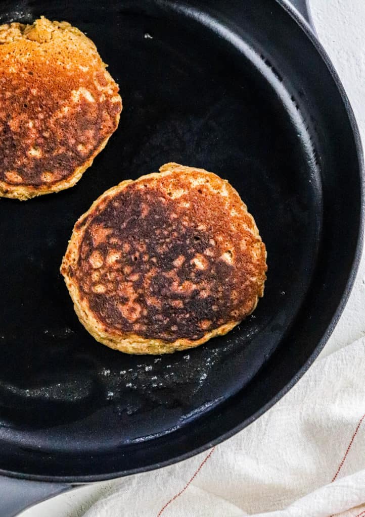 Golden brown cooked pancakes in a black skillet