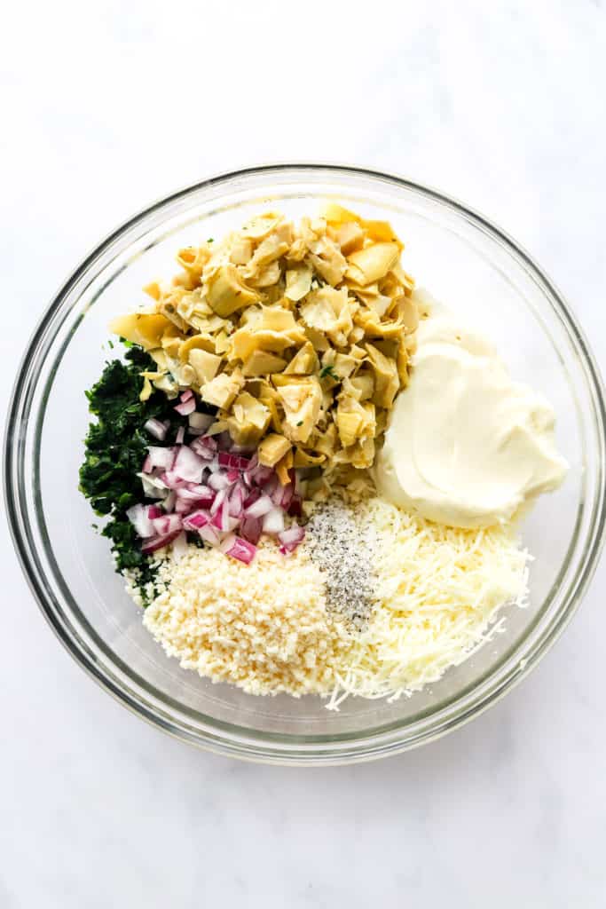 Froze spinach, chopped red onion, mayo, Greek yogurt and cheese in a round, glass mixing bowl