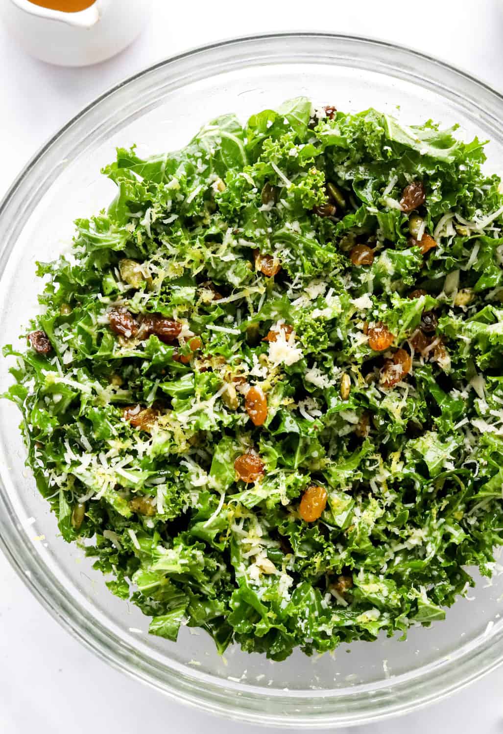 Mixed up salad with kale and topped with parmesan cheese, nut and lemon zest