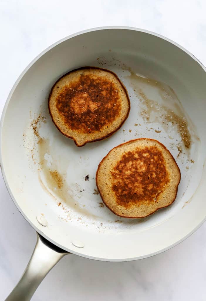 Golden brown, cooked pancakes in a round grey pan 