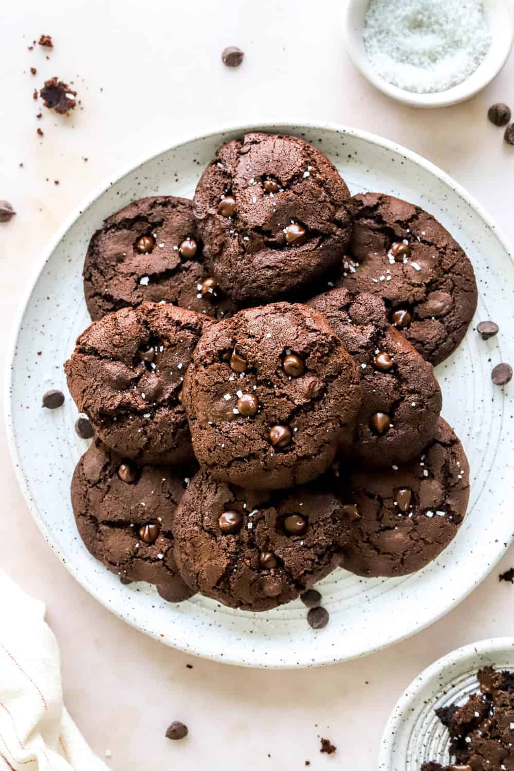 Round platter filled with chocolate air fryer cookies with a small bowl of salt behind them. 
