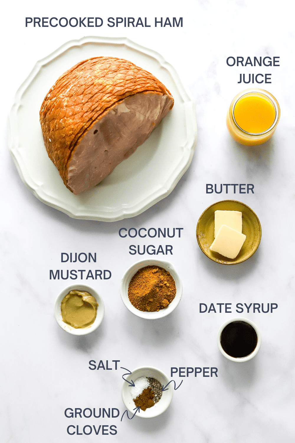 Air fryer baked ham ingredients on a white surface with labels over the top of each ingredient. 