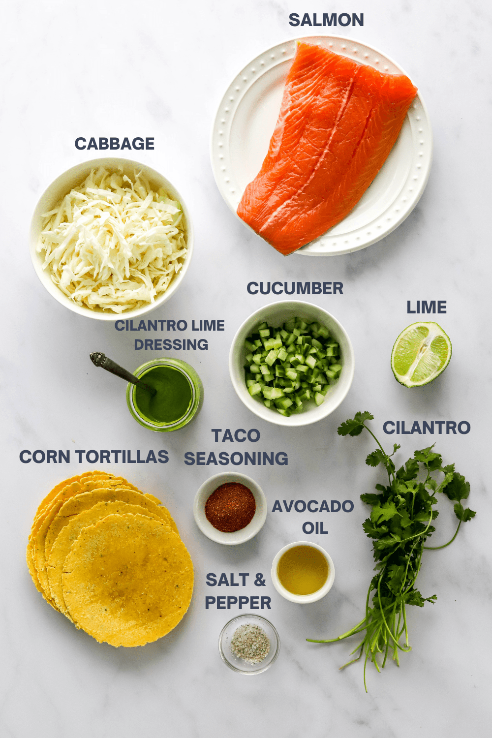 Ingredients for salmon tacos with cilantro lime slaw with labels over each ingredient. 