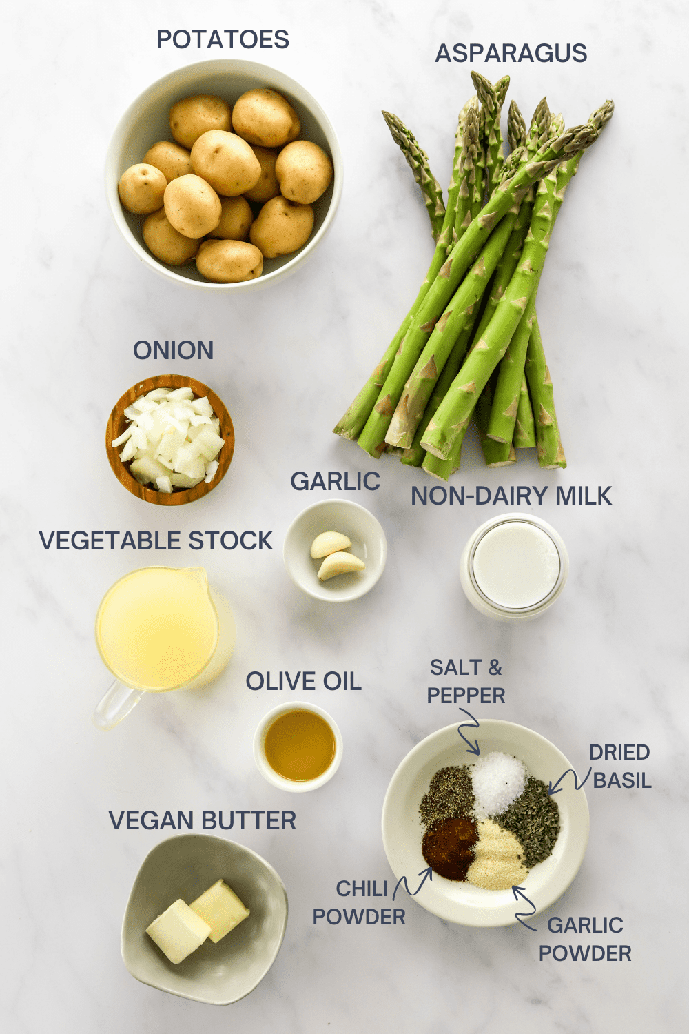 Asparagus soup ingredients on a white surface with labels over the top of each ingredient. 