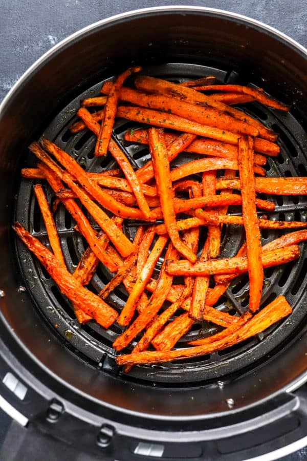 Crispy golden cooked carrot fries in an air Fryer basket