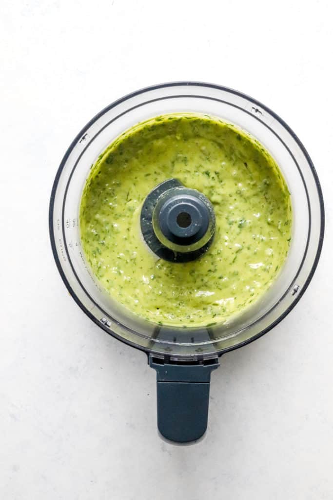 Blended creamy cilantro dressing in a food processor