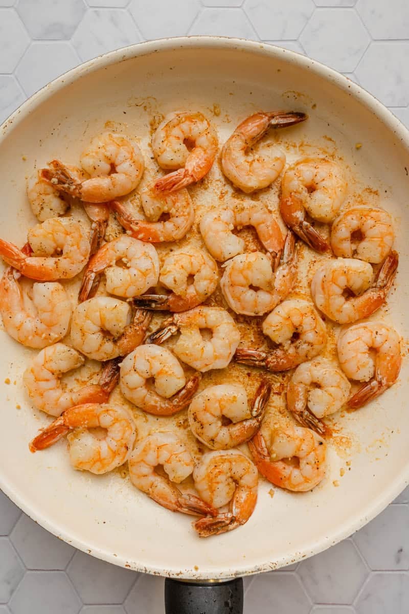 Sautéed shrimp in a pan. 