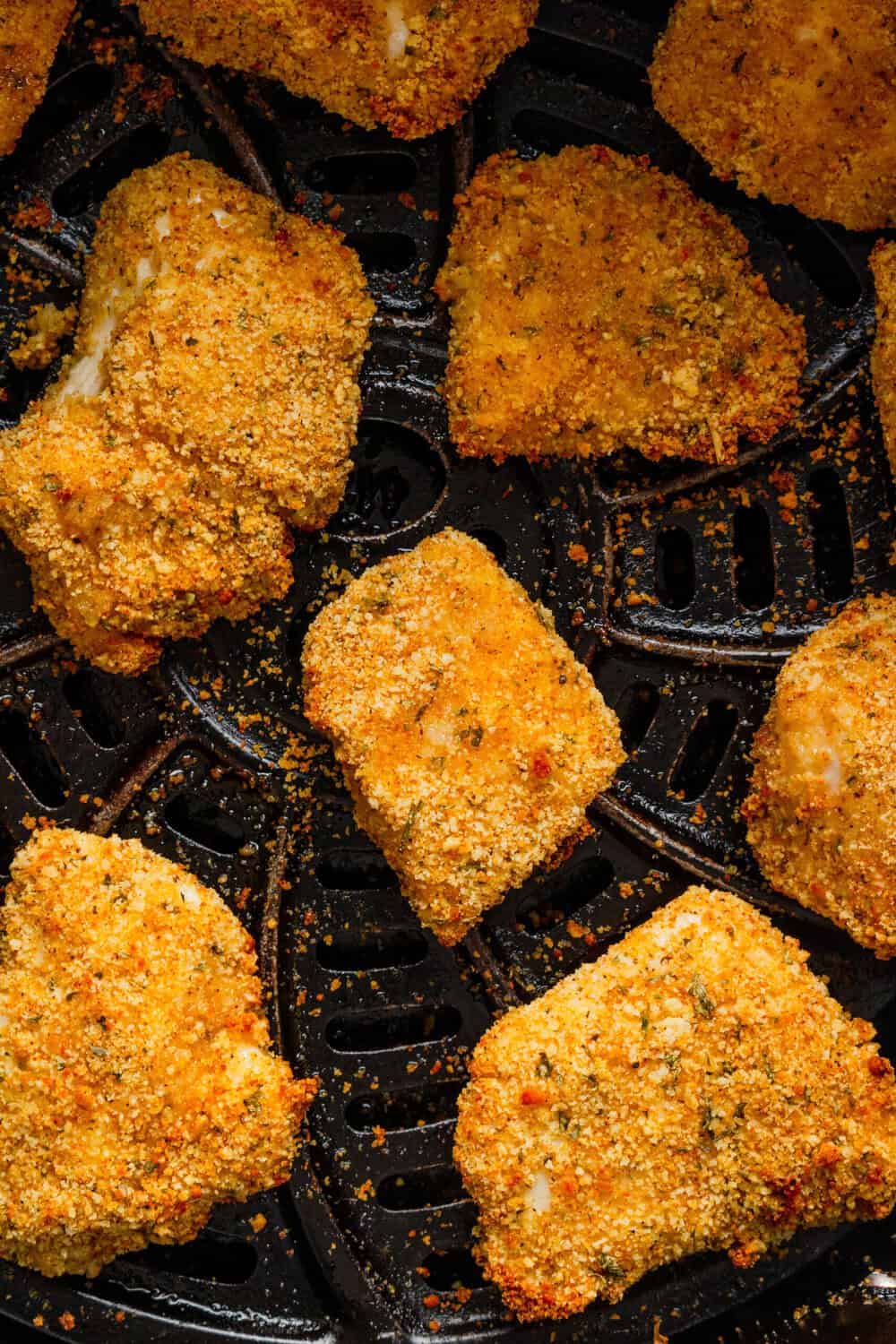 Crispy air fried breaded chicken nuggets in an air fryer basket. 