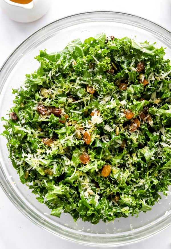 Mixed up salad with kale and topped with parmesan cheese, nut and lemon zest