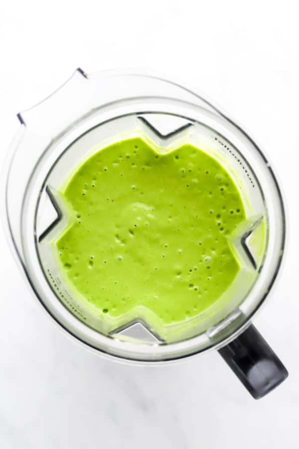 Pitcher filled with blend green smoothie mixture