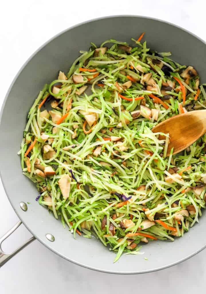Cooking broccoli slaw in a pan. 