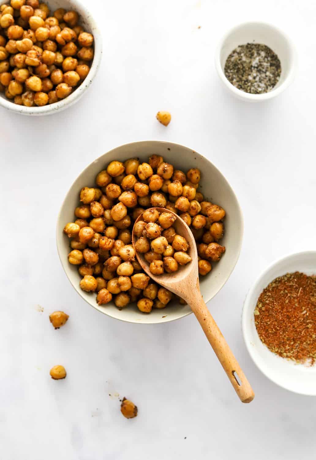 Crispy chickpeas in a bowl with more chickpeas in a bowl behind it. 
