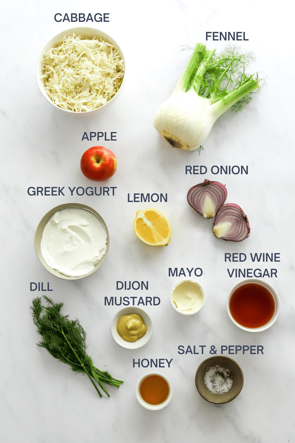 Fennel slaw ingredients on a white board with labels over each ingredient. 