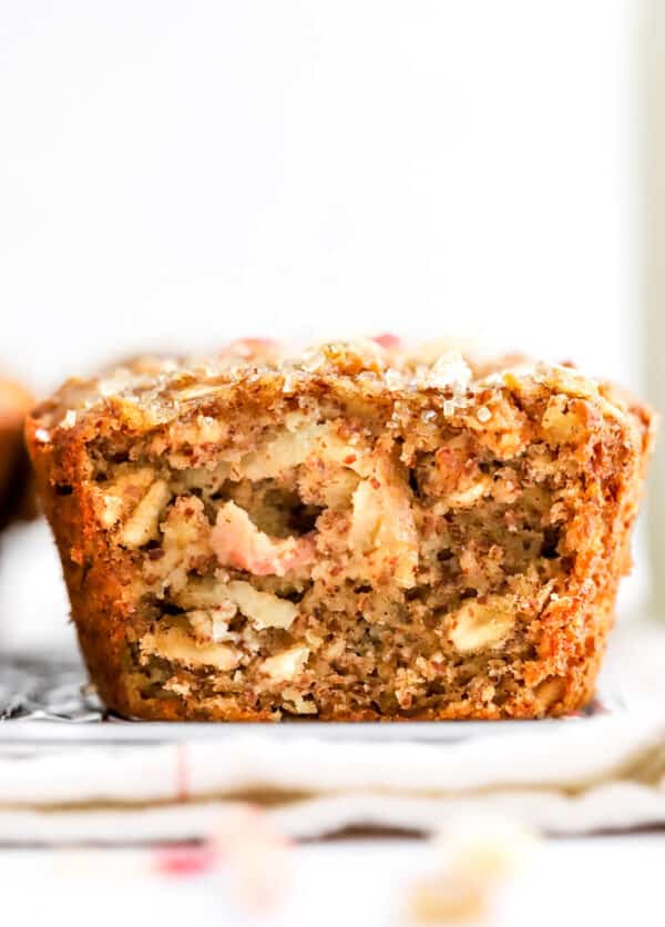 Large apple muffins with the front sliced off so you can see the center.