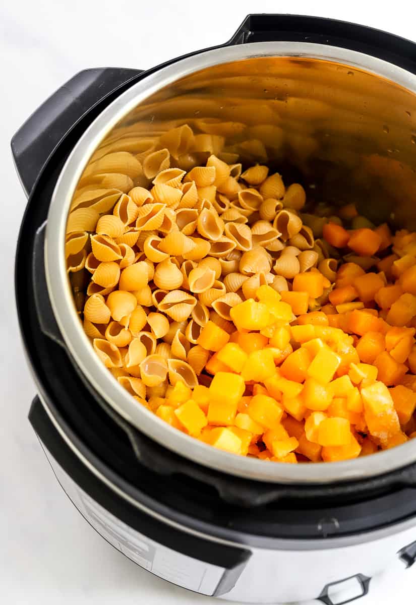 Diced squash and shell pasta in an instant pot.