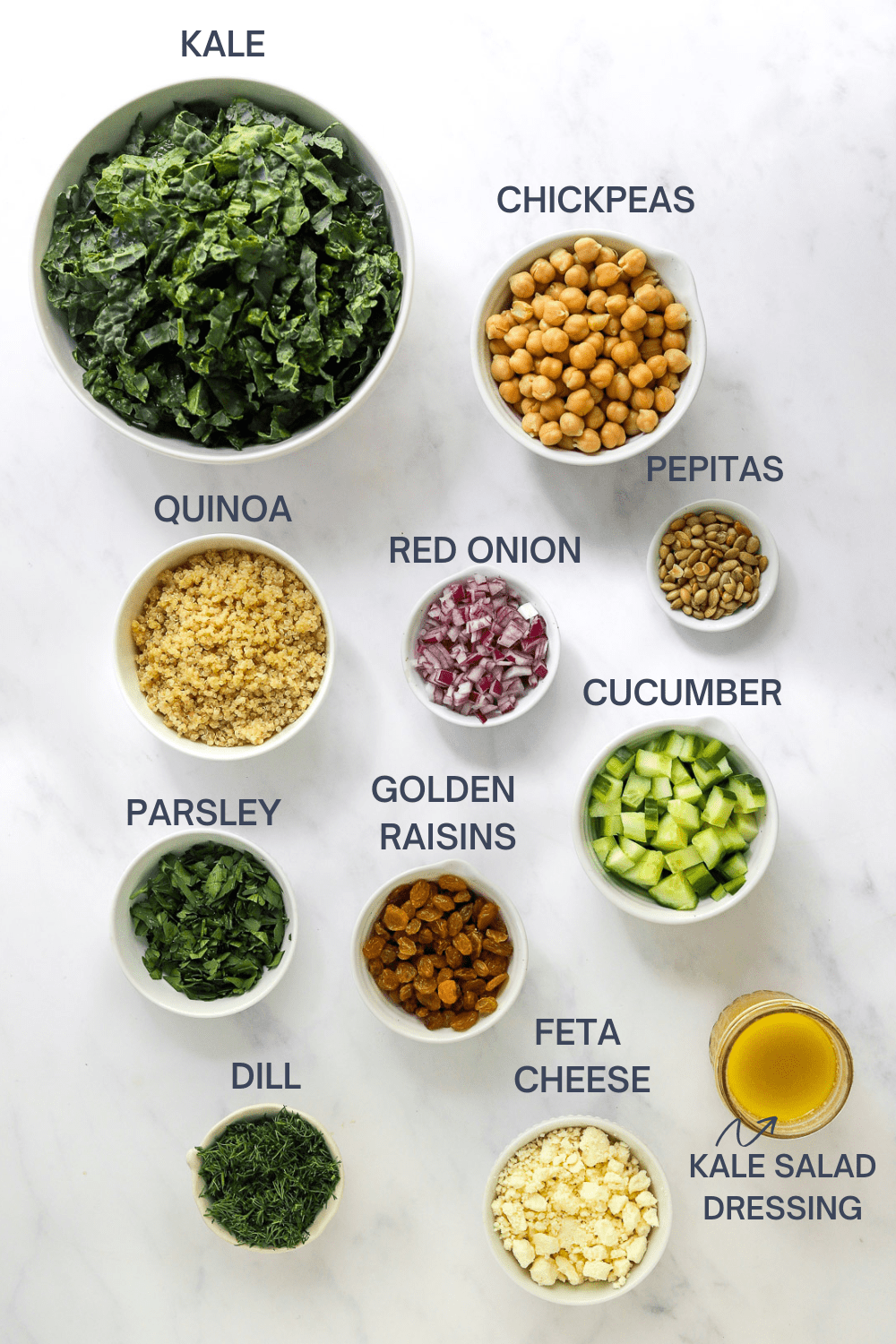 Bowls with ingredients for kale salad with labels for each ingredient. 