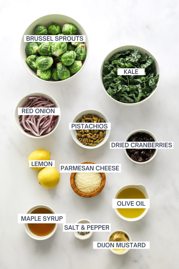 Ingredients for kale Brussel sprout salad with labels over each ingredient.