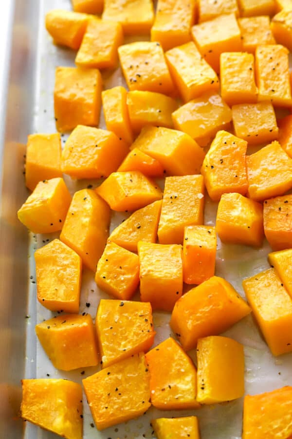 Tender cooked cubes of squash on a baking sheet.