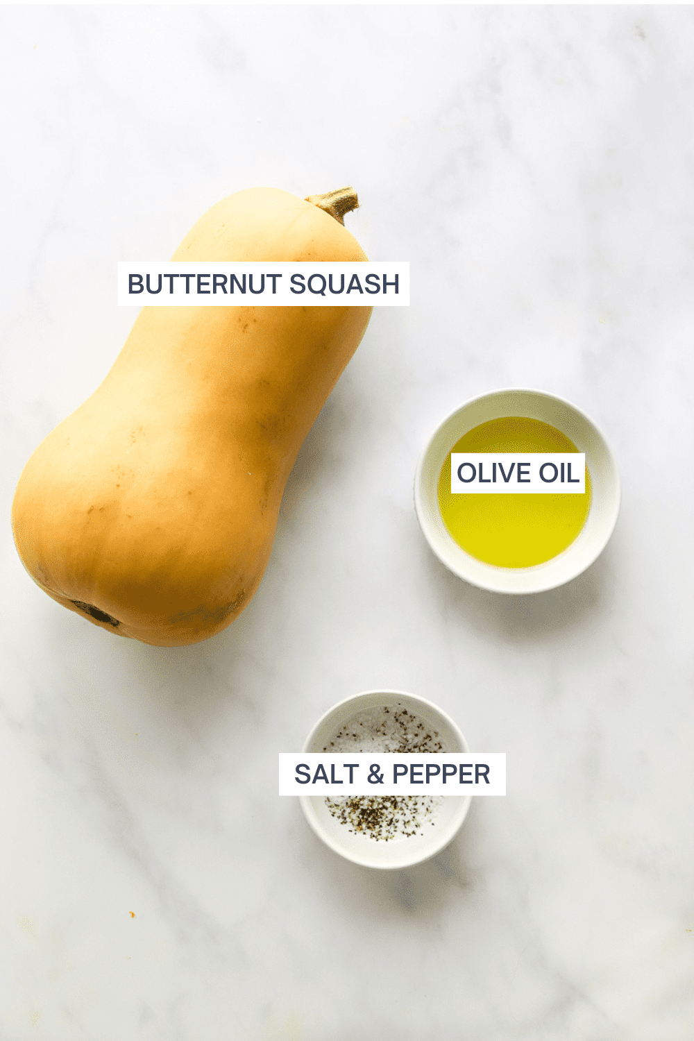 Whole butternut squash with a small white bowl filled with olive oil next to it and a small white bowl filled with salt and pepper in front of it. 