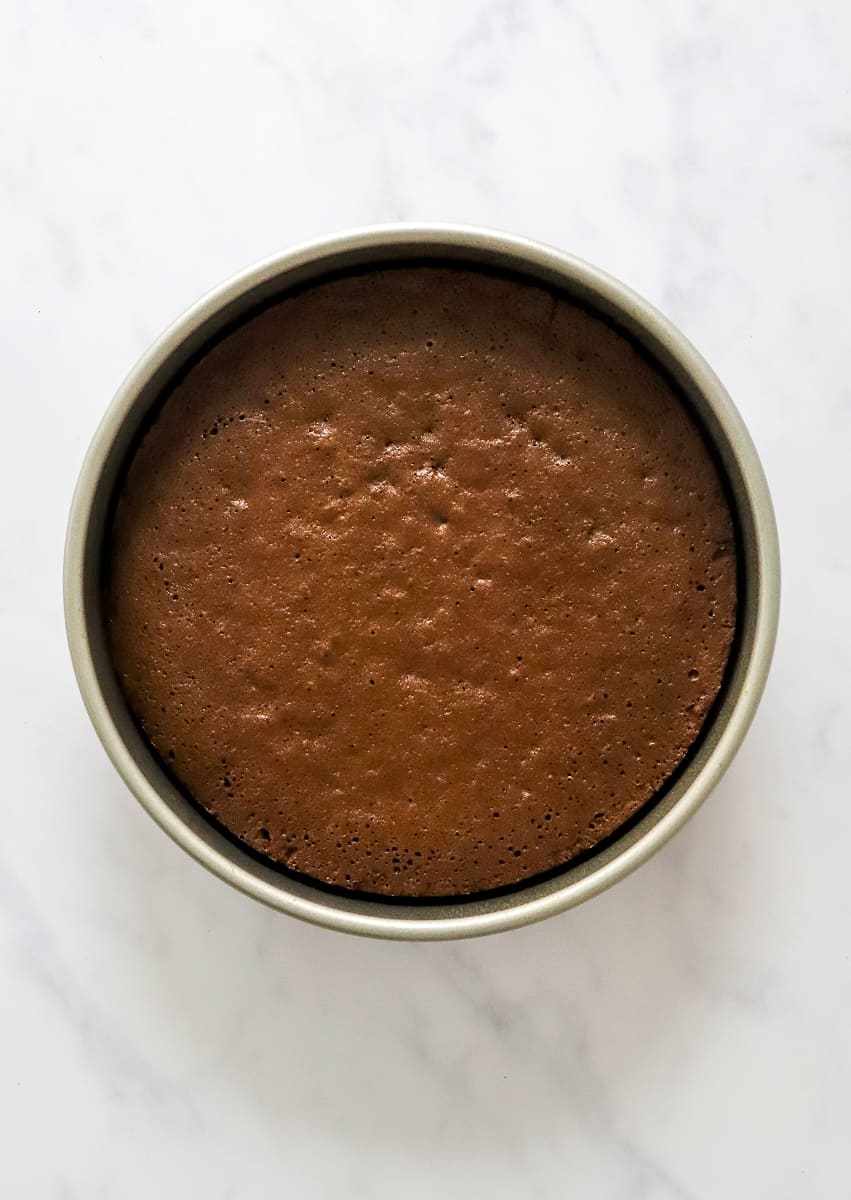 Baked brownies in a round cake pan. 
