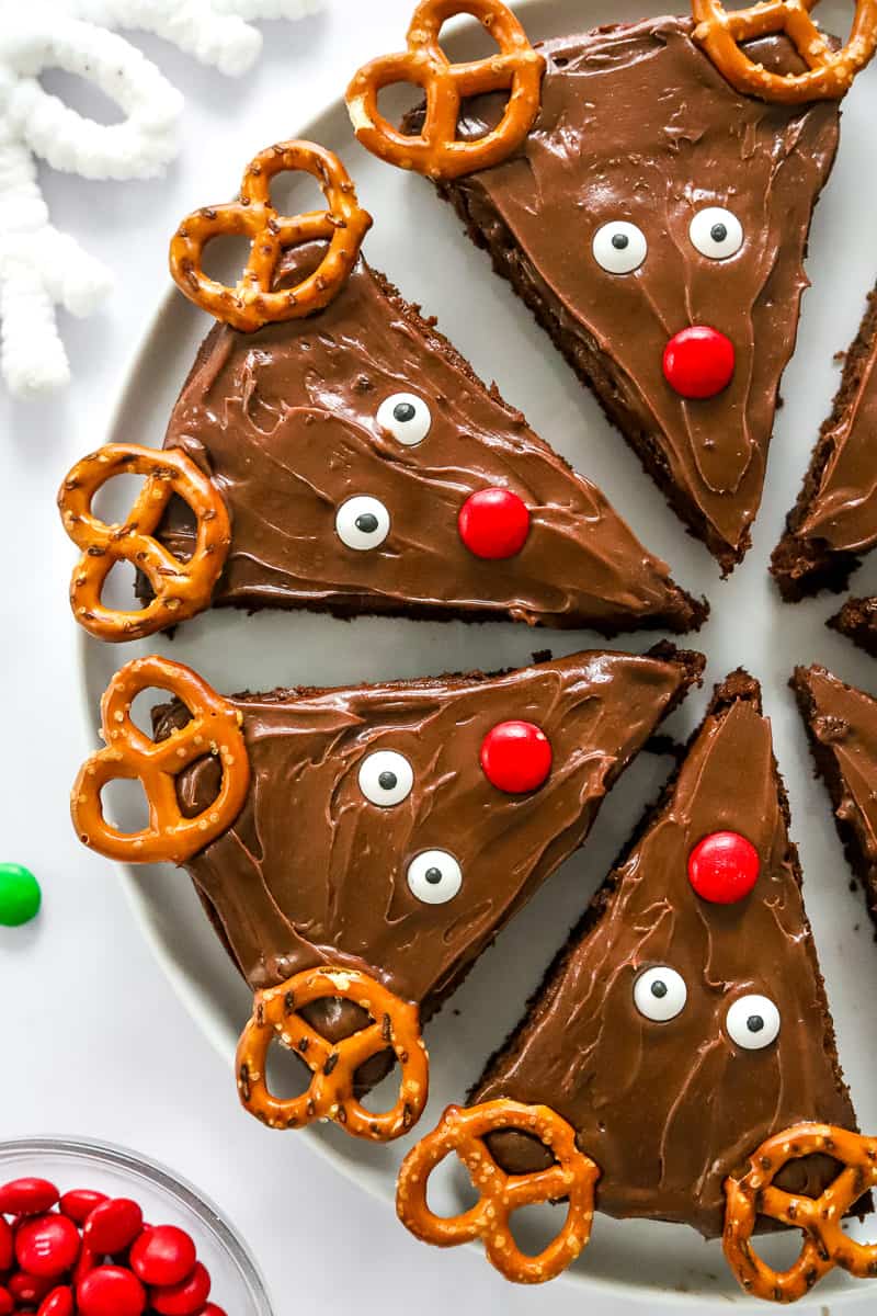 4 triangle shaped brownies decorated like reindeer on a plate. 