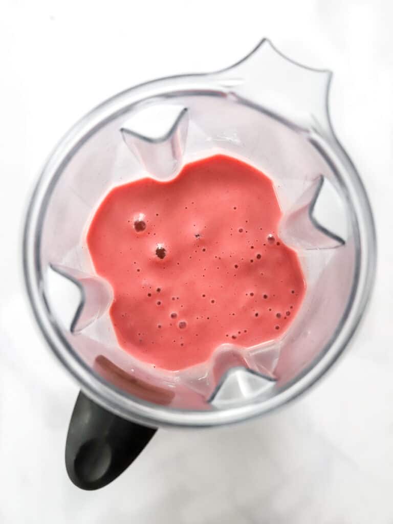 Blended strawberry smoothie in a blender.