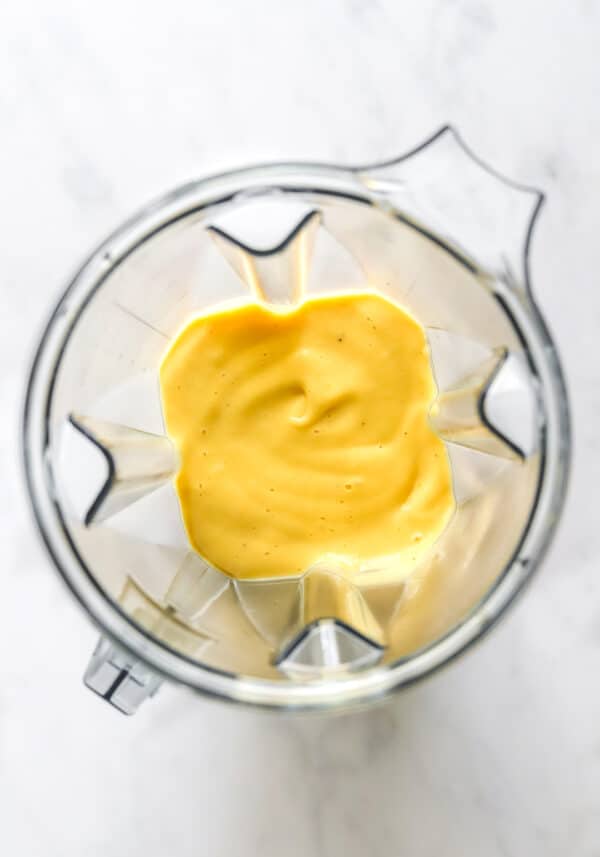 Blended mango Smoothie in a blende pitcher.