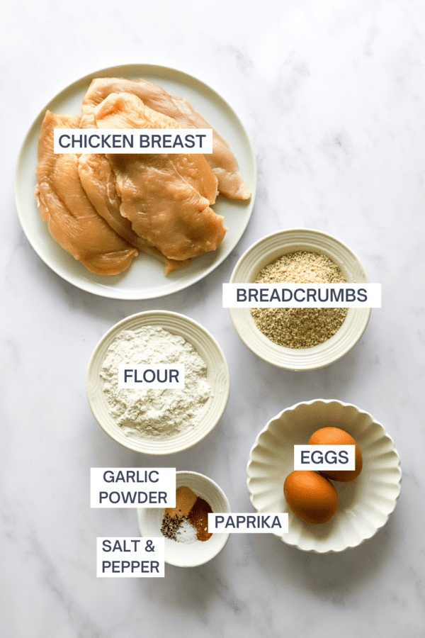 Ingredients for air fryer chicken cutlets in bowls with labels over each ingredient.