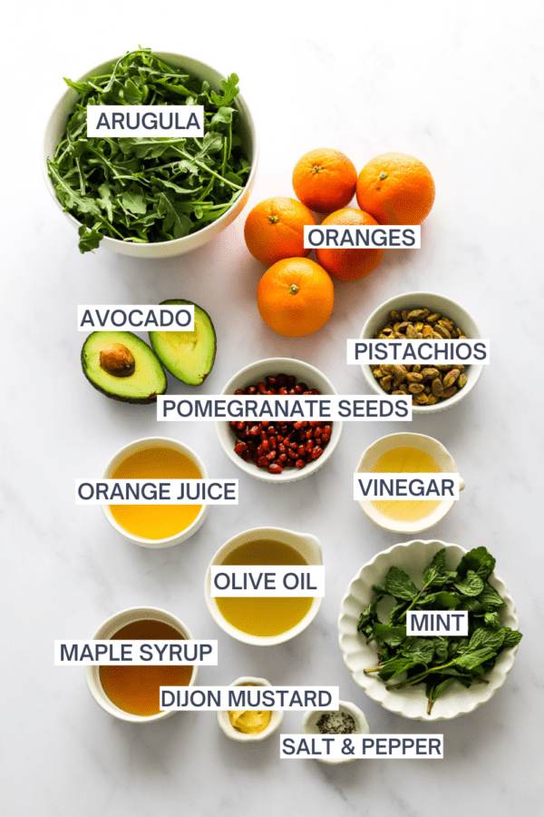 Ingredients for citrus salad with labels over each ingredient.