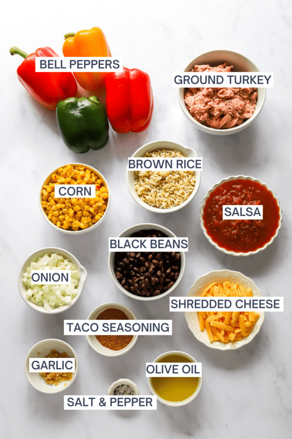 Ingredients for tacos stuffed bell peppers with labels over each ingredient.