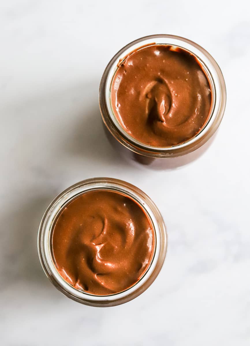 2 glass jars filled with a creamy chocolate mixture.