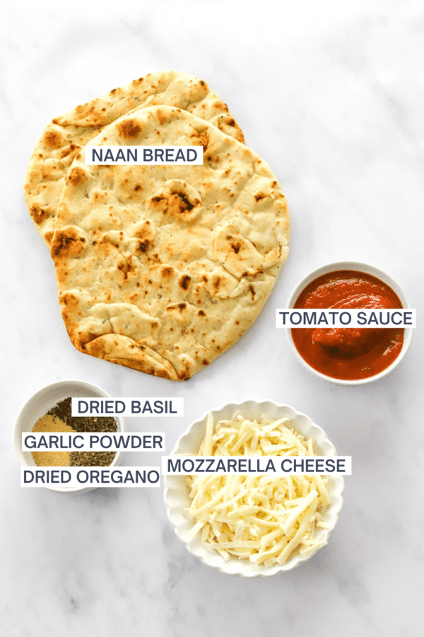 Ingredients for naan pizzas with labels over each ingredient.