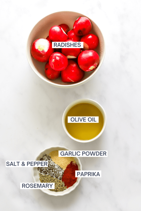 Bowl of red radishes, with a bowl of olive oil and a bowl of spices in front of it with labels over each ingredient.