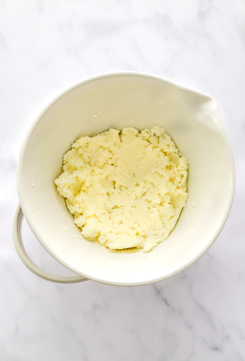 Sugar and butter creamed in a mixing bowl.