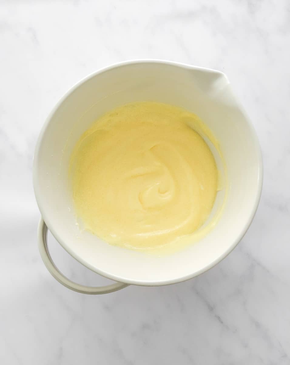 Yellow pudding like mixture in a mixing bowl.